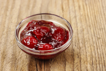 Bowl of marmalade on wooden table
