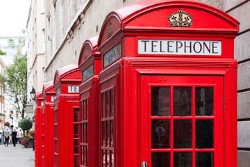 Traditional red telephone booths in London - Powered by Adobe