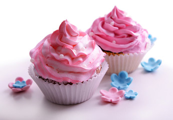 Delicious cupcakes isolated on white