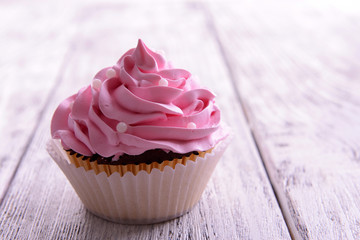 Delicious cupcake on table close-up