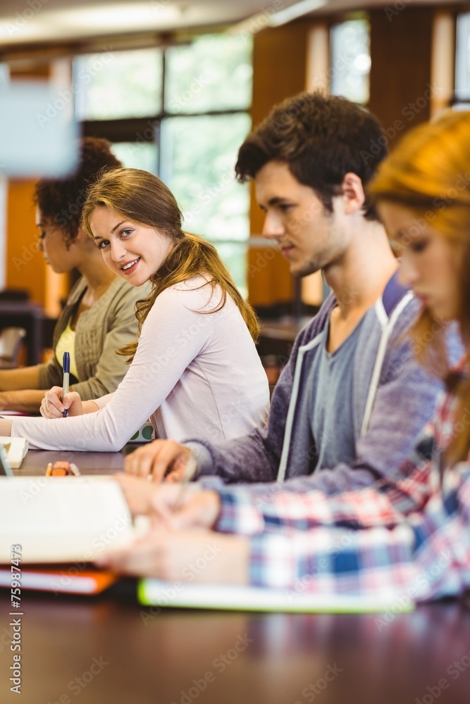 Aufkleber Student looking at camera while studying with classmates