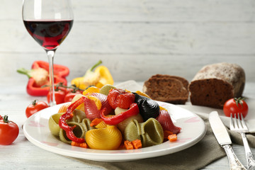 Tasty multicolor pasta with pepper, carrot and tomatoes