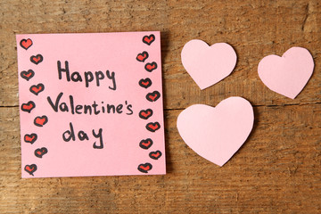Valentines day note on wooden background