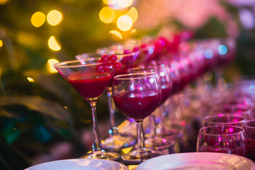 Line of different colored cocktails with smoke on a party