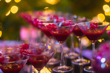Line of different colored cocktails with smoke on a party