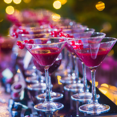 Line of different colored cocktails with smoke on a party