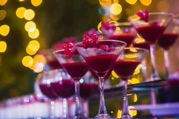 Line of different colored cocktails with smoke on a party