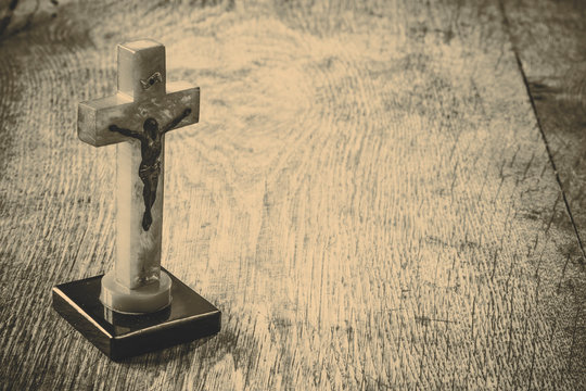 Beautiful old cross with jesus on the old wooden floor