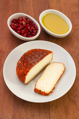 cheese on dish and pink pepper with oil