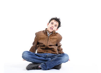 Obraz premium Scared boy sitting cross-legged