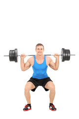 Fototapeta na wymiar Strong man exercising with a barbell