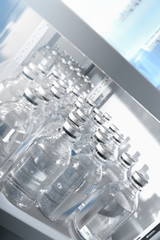 Medical solutions in bottles standing in warehouse
