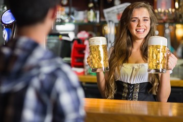 Smiling oktoberfest barmaid with beer