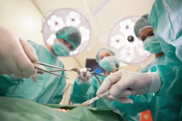 Medical students practicing surgery on model