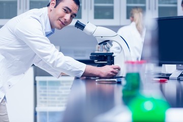 Science student working with microscope in the lab