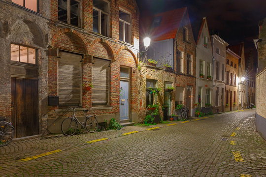 Cityscape with the picturesque night street in Bruges