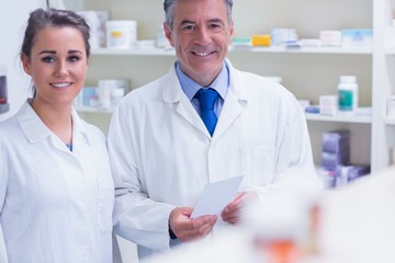 Pharmacist and his trainee looking at the camera