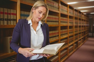 Serious librarian reading a book