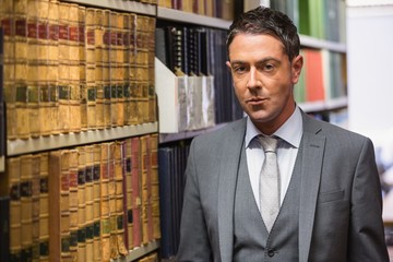 Lawyer looking at camera in the law library