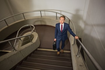 Businessman going up the stairs