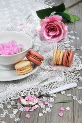Obraz na płótnie Canvas Valentine's Day: Romantic tea drinking with macaroon and hearts