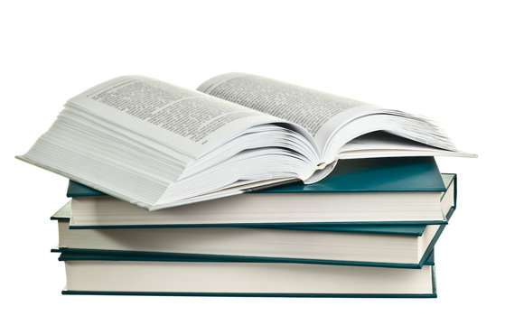 Open book lying on a pile of books