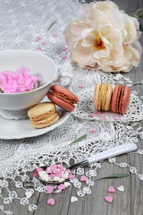 Fototapeta na wymiar Valentine's Day: Romantic tea drinking with macaroon and hearts