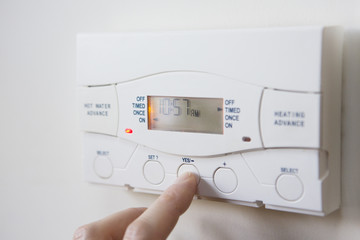 Close Up Of Hand  Setting Control For Heating And Hot Water