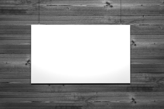 white canvas hanging in front of grey wooden wall
