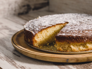 Sponge cake of lemon over wooden background