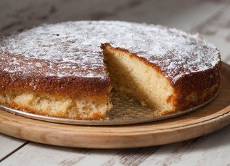 Sponge cake of lemon over wooden background