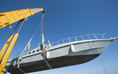 Boat being lifted by heavy crane machinery