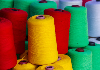 Tubes with colorful thread yarn.