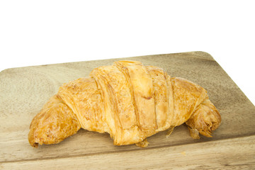 Fresh croissants on wooden table