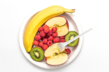 Sweet fresh fruits on plate isolated on white