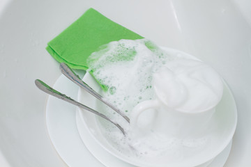 white dishes in foam