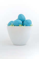 Blue speckled eggs in Easter grass