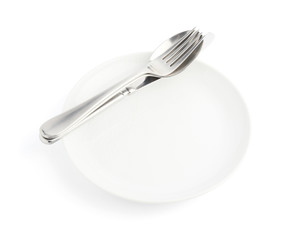 Spoon, fork and knife over the white plate