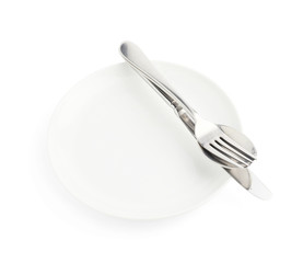 Spoon, fork and knife over the white plate