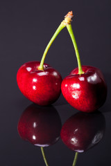 fruit of ripe red cherry isolated on dark background