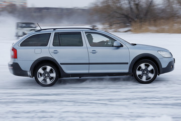 Obraz na płótnie Canvas Car driving on a snowy road