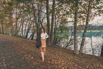 Fototapeta premium Beautiful young woman posing in a city park
