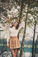 Beautiful young woman posing in a city park