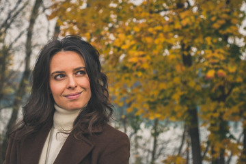 Beautiful young woman posing in a city park