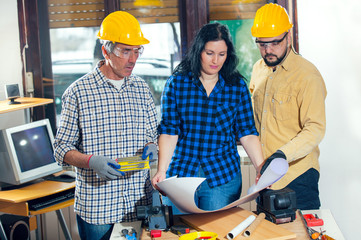 Construction worker and couple looking at the plan