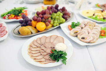 The image of the dishes and food on the served table