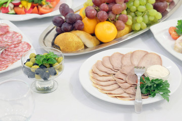 The image of the dishes and food on the served table