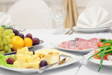 The image of the dishes and food on the served table