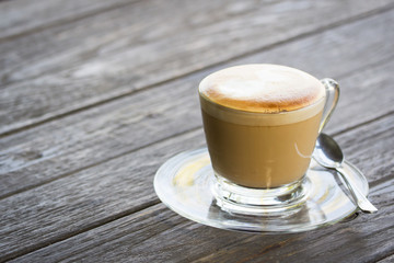 Coffee on glass on wood table
