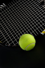 Green Tennis Ball with Racquet Dark Background